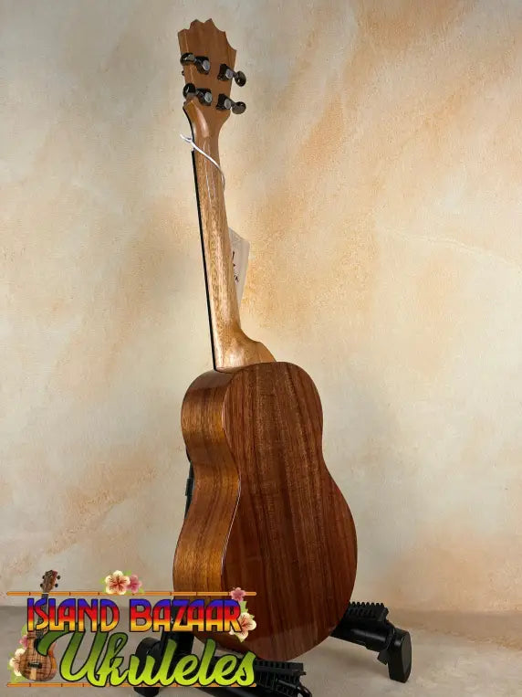 Wooden KoAloha KTM-00 Tenor Ukulele on stand showcasing authentic Hawaiian sound