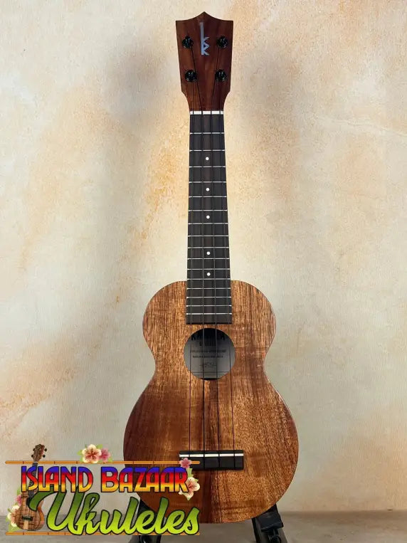 Wooden Kamaka Soprano Ukulele HF-1 with dark finish and black fretboard, solid Koa