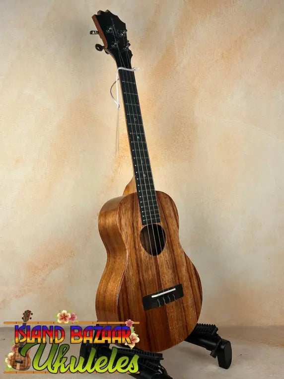 Wooden KoAloha KTM-00 Tenor Ukulele on stand with solid Hawaiian koa and authentic Hawaiian sound