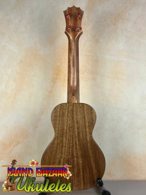 Wooden KoAloha Opio Concert Ukulele with natural grain finish and dark tuning pegs