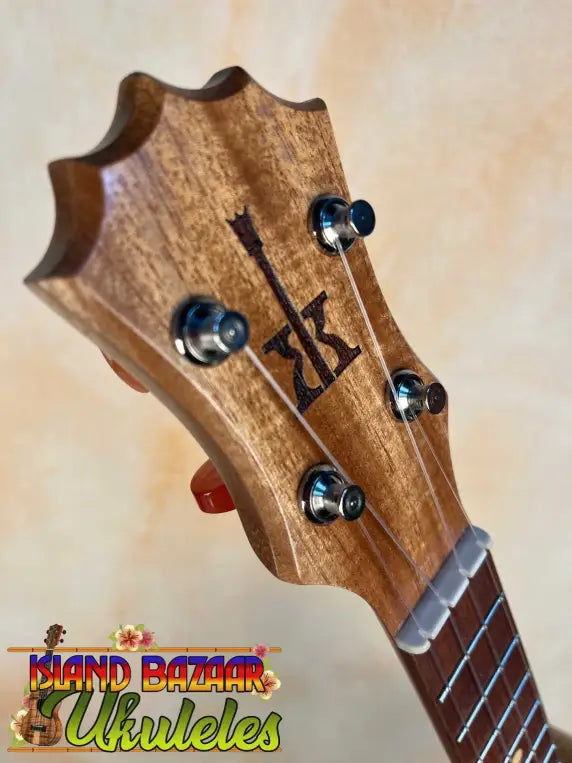 Wooden guitar headstock with tuning pegs on a KoAloha Opio Concert Ukulele
