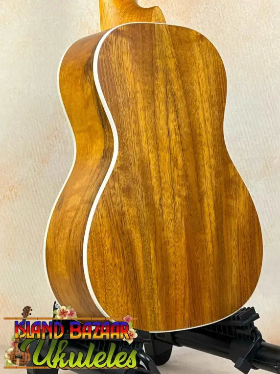 Wooden acoustic guitar with natural finish in Concert Mango Ukulele Beginners Bundle