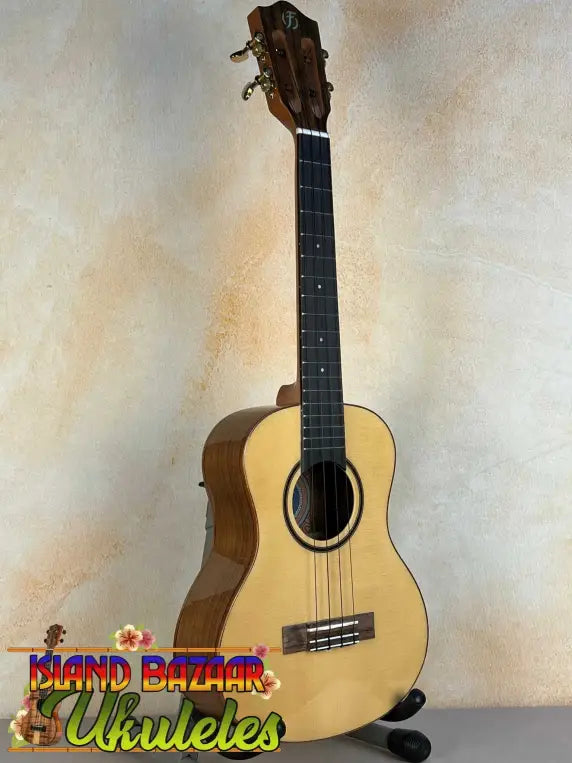 Natural wood Flight Sophia Soundwave Tenor Uke displayed on a black stand