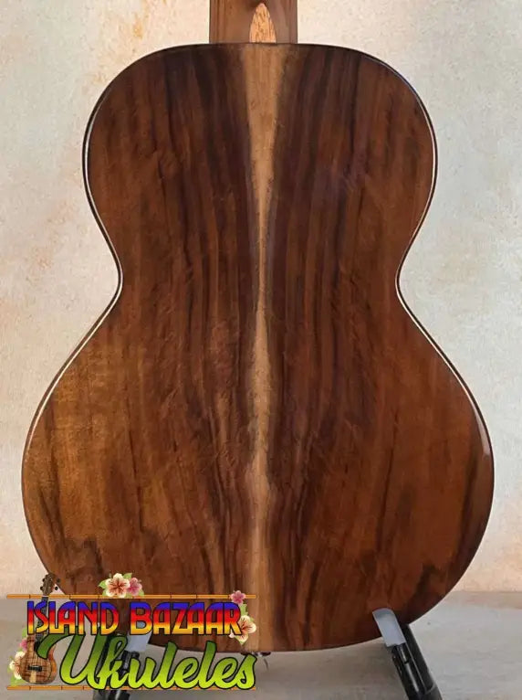 Wooden acoustic guitar back panel showcasing rich grain on Flight Voyager Tenor Ukulele