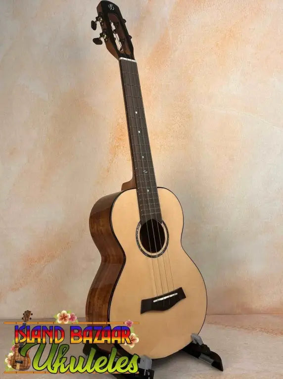 Natural wood Flight Voyager tenor ukulele on black stand with Flight gig bag