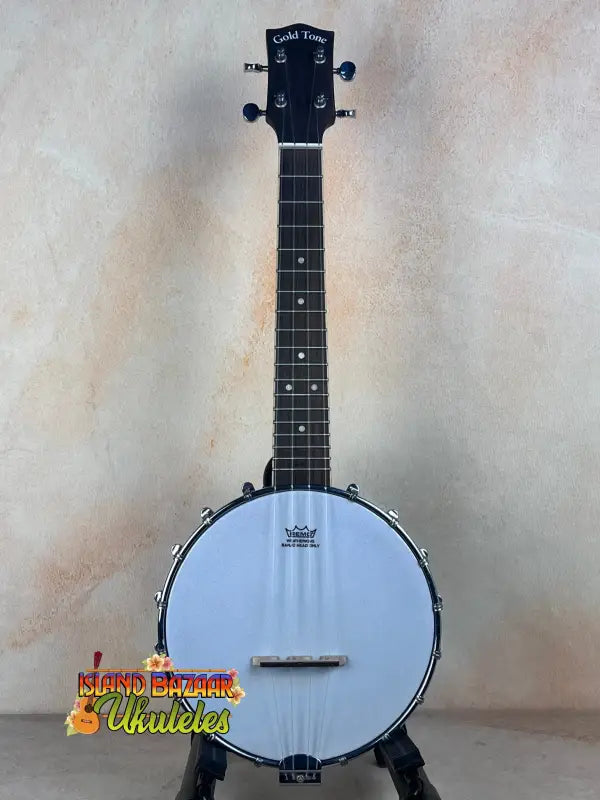 Gold Tone Concert-Scale Banjolele with a white head and black tuning pegs and hardshell case
