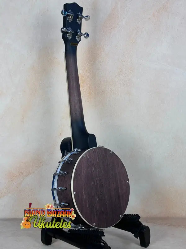 Gold Tone Concert-Scale Banjolele with Hardshell Case resting on a black stand