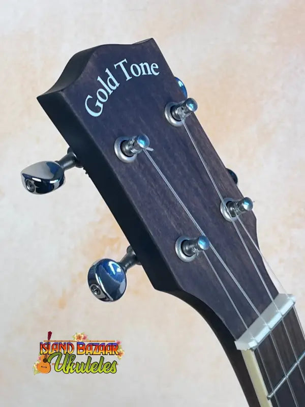 Guitar headstock of Gold Tone Concert-Scale Banjolele featuring tuning pegs and logo