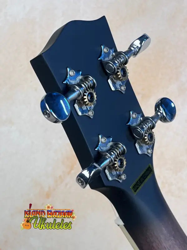 Guitar headstock with chrome tuning pegs and blue accents on Gold Tone Concert-Scale Banjolele