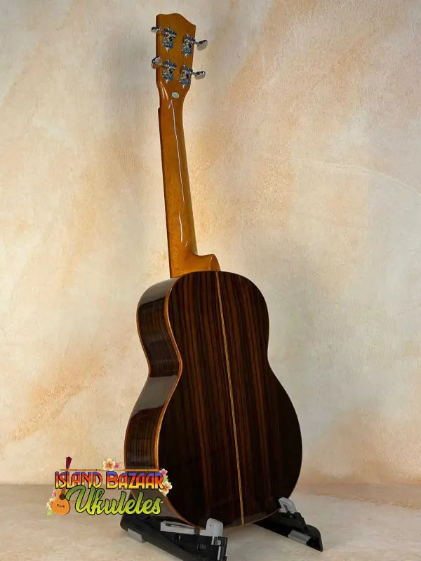 Wooden baritone ukulele with dark rosewood back, showcasing Ohana TK-50G design