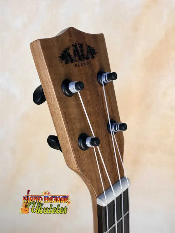 Wooden headstock of Kala Cedar & Acacia Tenor Ukulele with black tuning pegs
