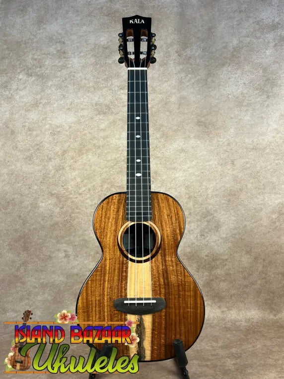 Brown wooden Kala Contour Series Tenor Ukulele with light stripe and black tuning pegs