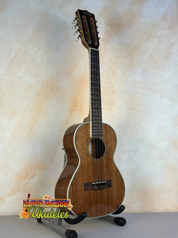 Wooden ukulele on stand, showcasing Kala KA-8 Eight-String Tenor in gloss mahogany finish