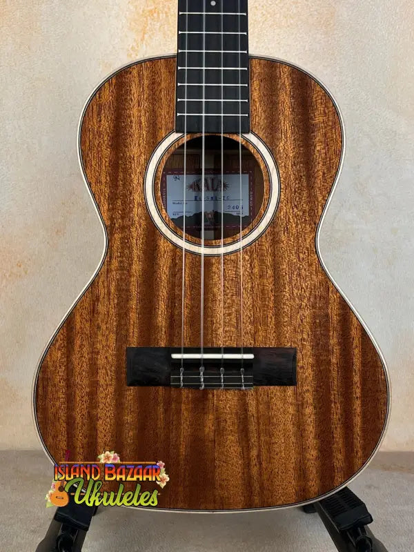 Kala KA-SMH-TG Solid Mahogany Tenor Ukulele with dark wood grain and black fretboard