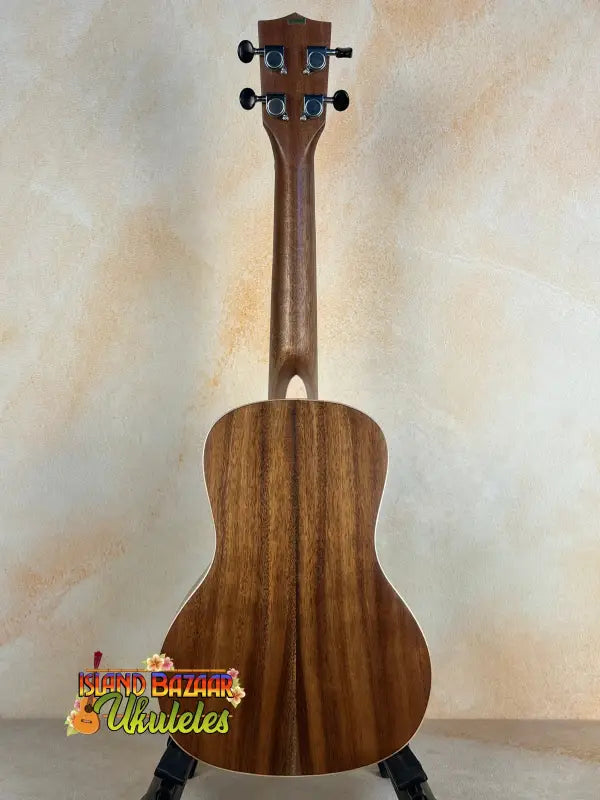 Wooden ukulele with dark grain and black tuning pegs, featuring Kala SA-C Concert design