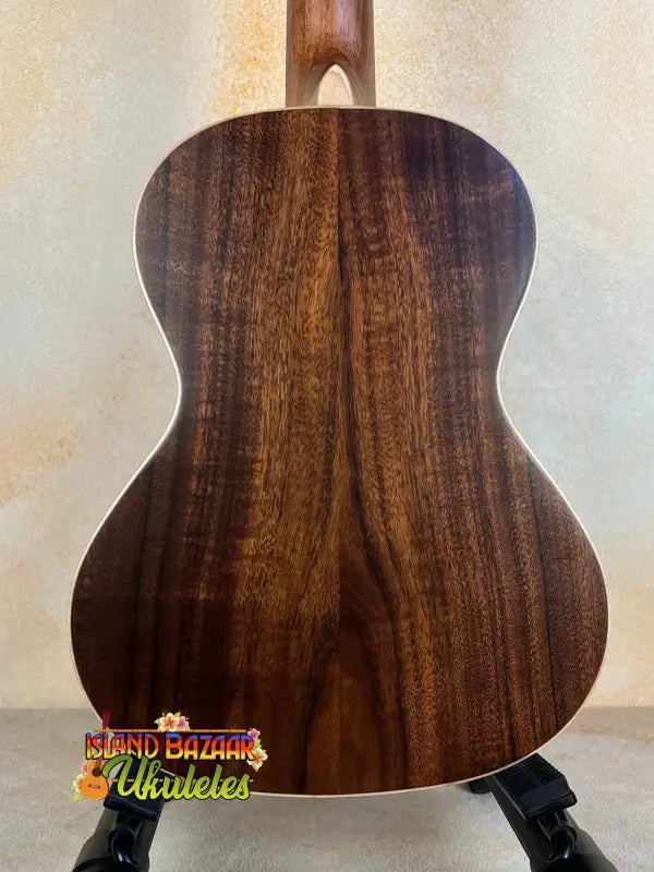 Acoustic guitar with dark wood grain back, showcasing the Kala SA-T Tenor Ukulele