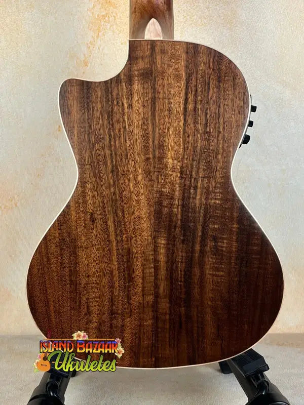 Acoustic guitar back panel of Kala SA-TE-C Tenor Electric with rich walnut wood grain