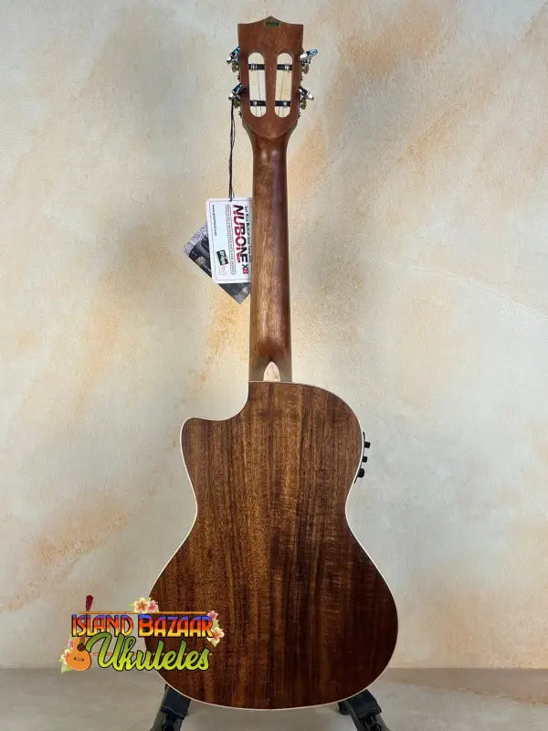Wooden acoustic guitar with dark finish featured in Kala SA-TE-C Tenor Electric Ukulele