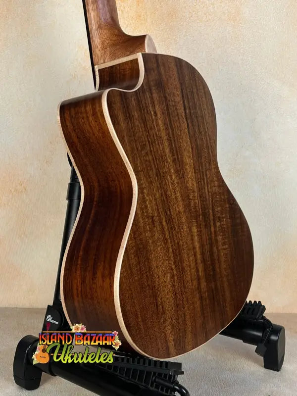 Acoustic guitar with dark wood back, showcasing Kala SA-TE-C Tenor Electric Ukulele