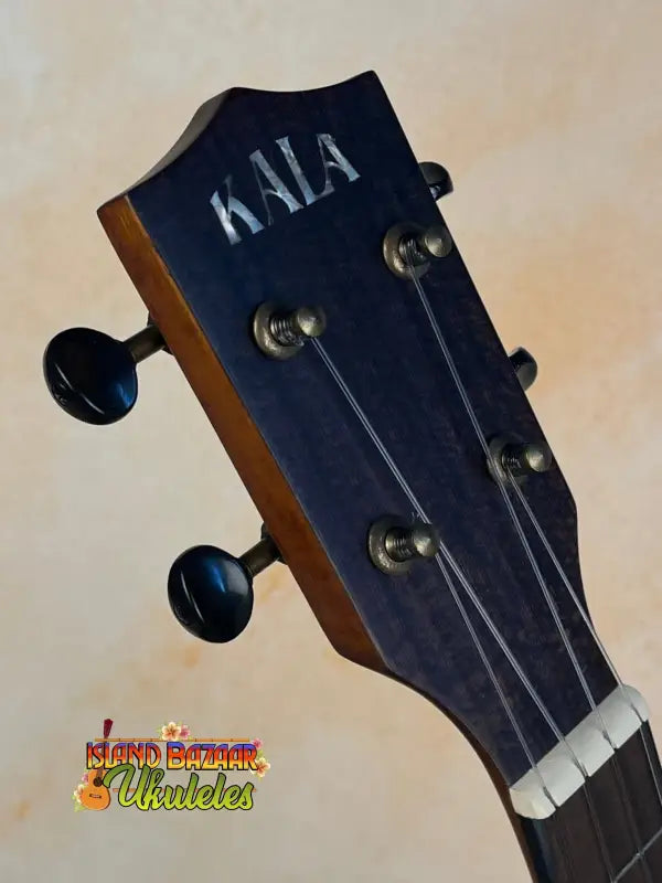 Kala Satin Hawaiian Koa Tenor Electric Ukulele headstock with black tuning pegs