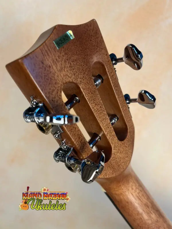 Wooden headstock with tuning pegs of the Kala SMH-CG Concert Ukulele in solid mahogany