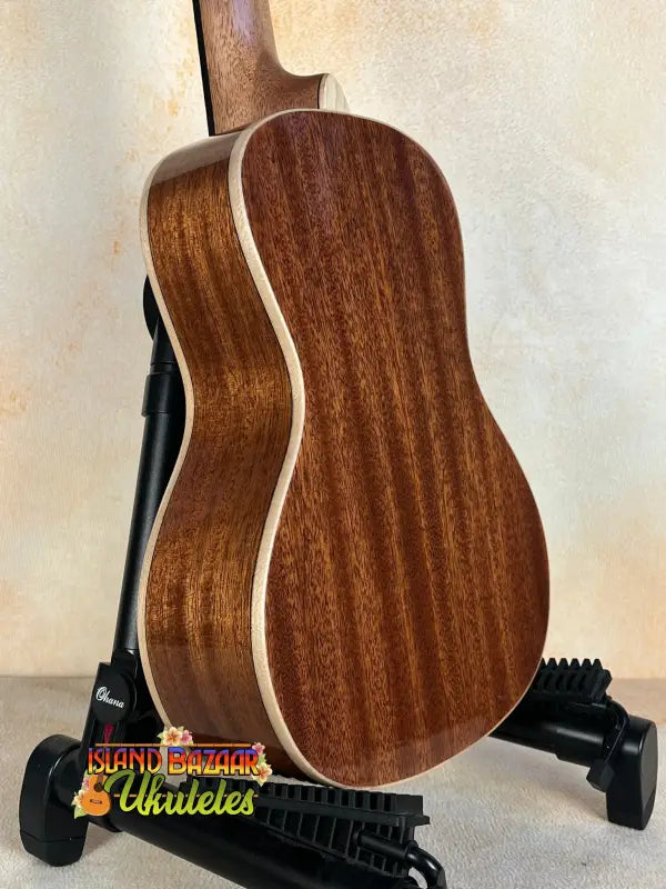 Wooden acoustic guitar on black stand for Kala SMH-CG Concert Ukulele with solid mahogany