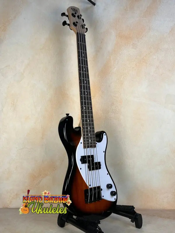 Sunburst-colored Precision Bass guitar on a stand with Kala Solid Body design