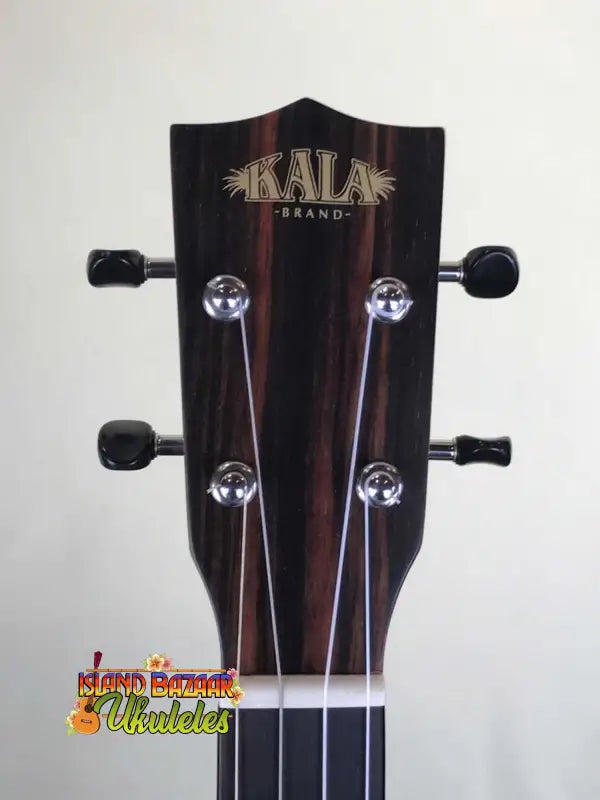 Kala Spruce Baritone ukulele headstock featuring four tuning pegs and Striped Ebony finish