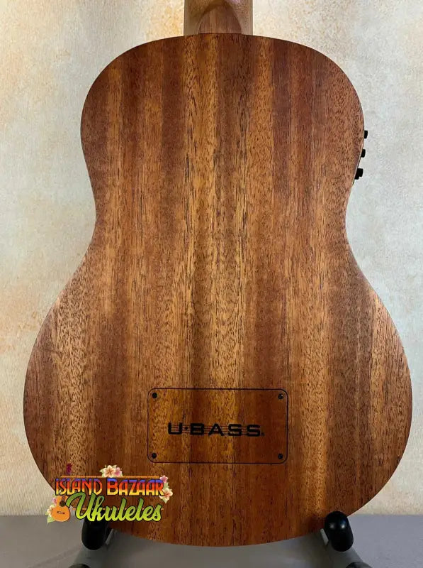 Wooden Kala U-Bass Nomad Acoustic-Electric Bass Ukulele with dark grain pattern