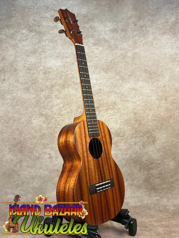 Brown wooden Kamaka HF-3 tenor ukulele showcased in the Hawaiian Koa Tone Machine product