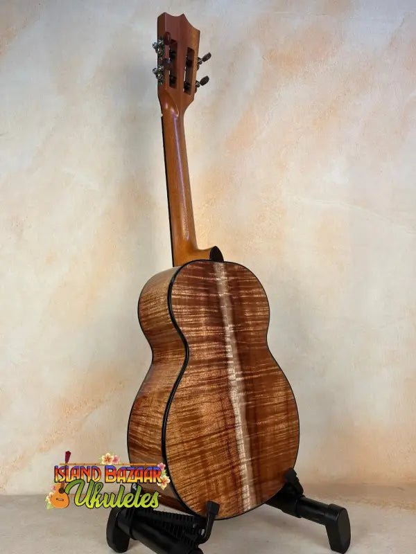 Wooden Kamaka HF3-D2i Tenor Uke Deluxe with unique grain on black stand in hard case