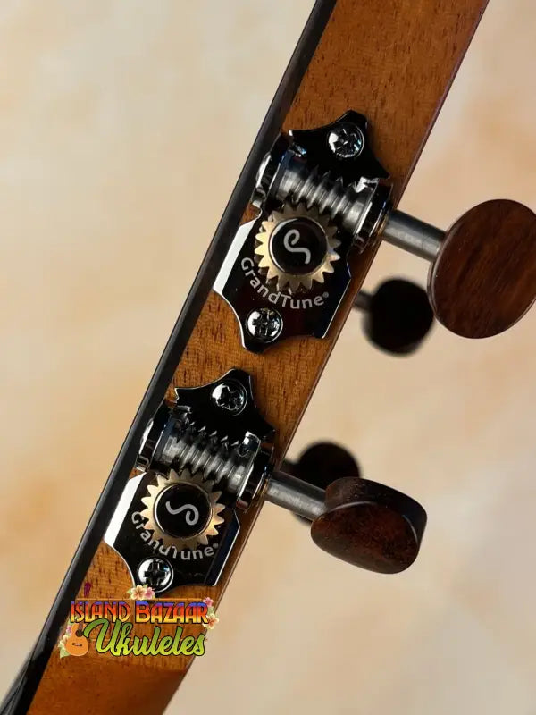 Guitar tuning pegs on a wooden headstock of the Kamaka HF3-D2i Tenor Uke Deluxe
