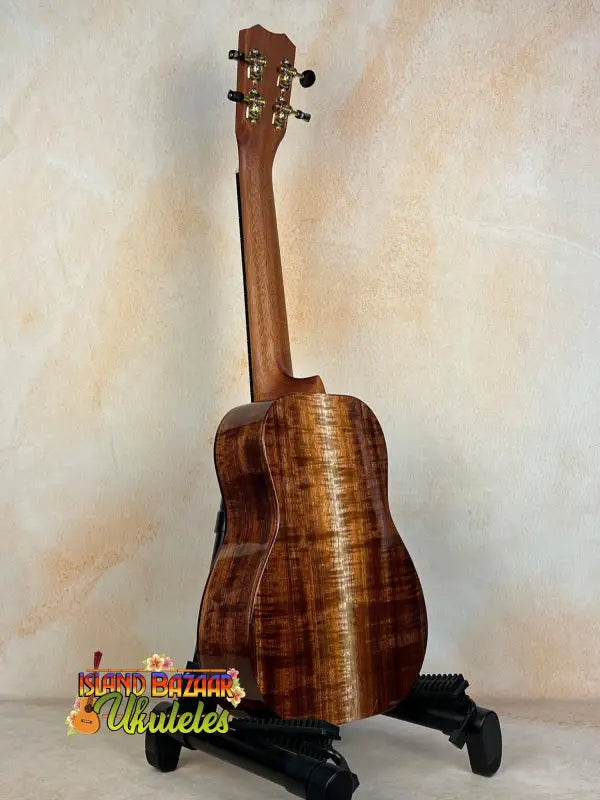 Wooden Kanile’a Concert Ukulele with curly koa wood grain and deluxe gig bag