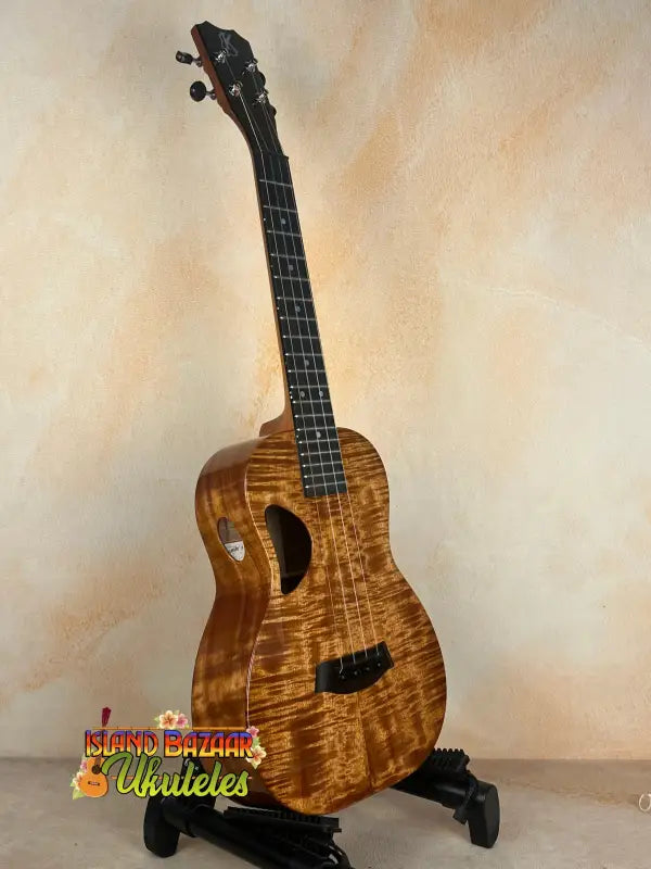 Brown Kanileʻa D-1 tenor ukulele with heart-shaped sound hole and solid Hawaiian koa