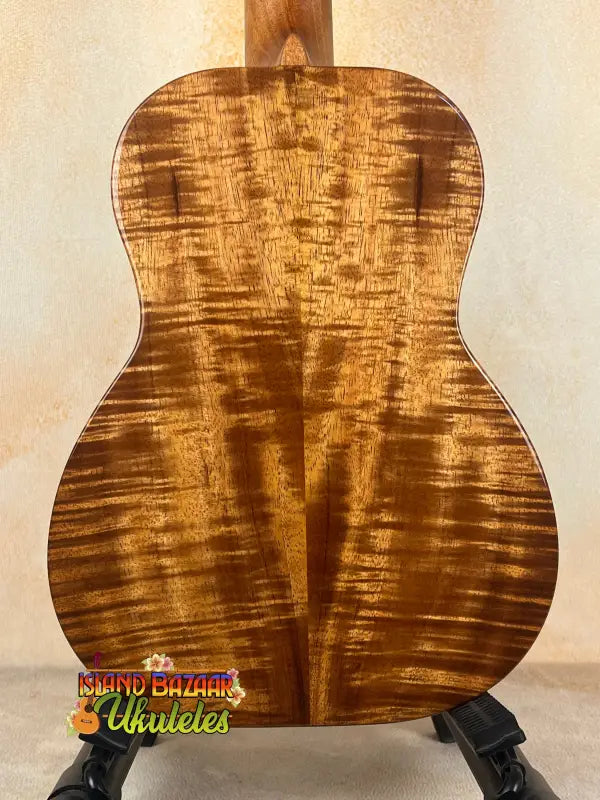 Figured koa ukulele back showcasing Kanileʻa D-1 T Pro tenor ukulele with deluxe gig bag