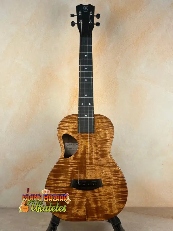 Brown patterned ukulele made of solid Hawaiian koa with deluxe gig bag and Kanileʻa D-1 design