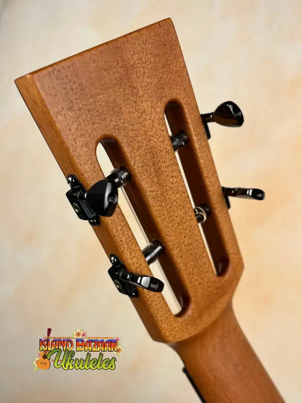 Ukulele headstock with black tuning pegs on Kanile’a DK-T Pro D-hole Tenor Ukulele with premium koa