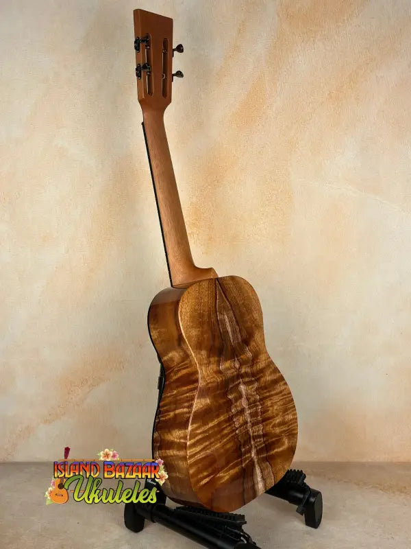 Wooden ukulele with striped pattern from Kanile’a DK-T Pro D-Hole Tenor Ukulele featuring premium koa