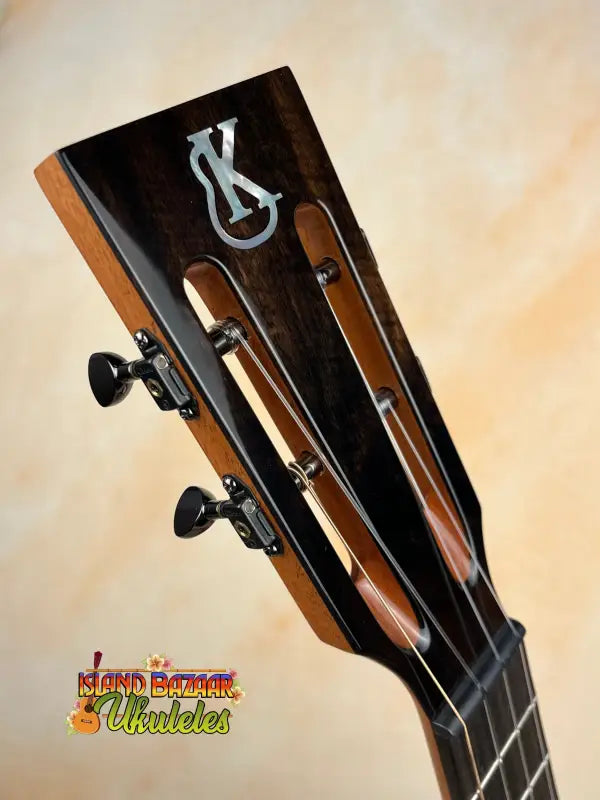 Ukulele headstock with tuning pegs on Kanile’a DK-T Pro Tenor Ukulele with premium koa