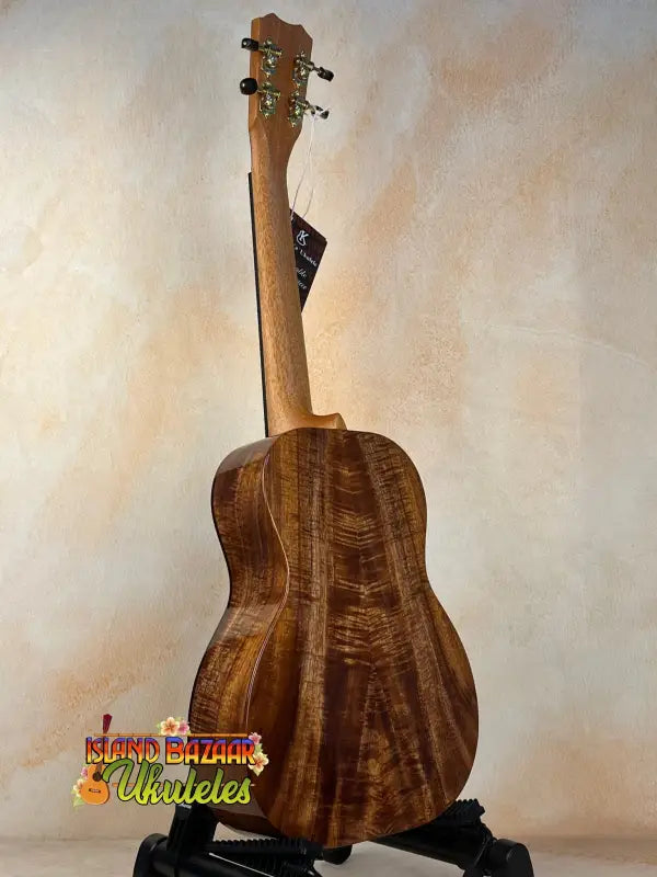 Acoustic guitar with rich brown wood grain, showcasing Kanile’a Hawaiian Islands Premium Koa Wood