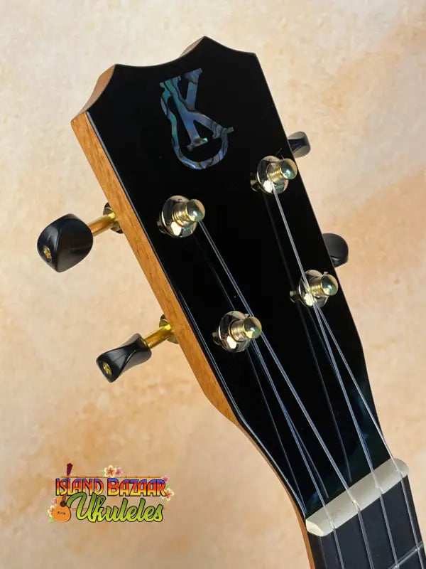 Guitar headstock of Kanile’a Hawaiian Islands Tenor Ukulele in premium koa wood finish