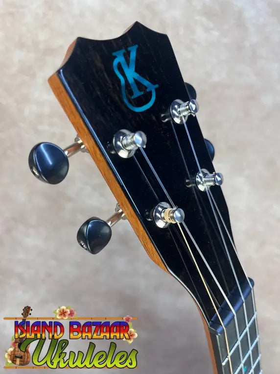 Black Kanilea Ilikai T Pro tenor ukulele headstock with teal logo