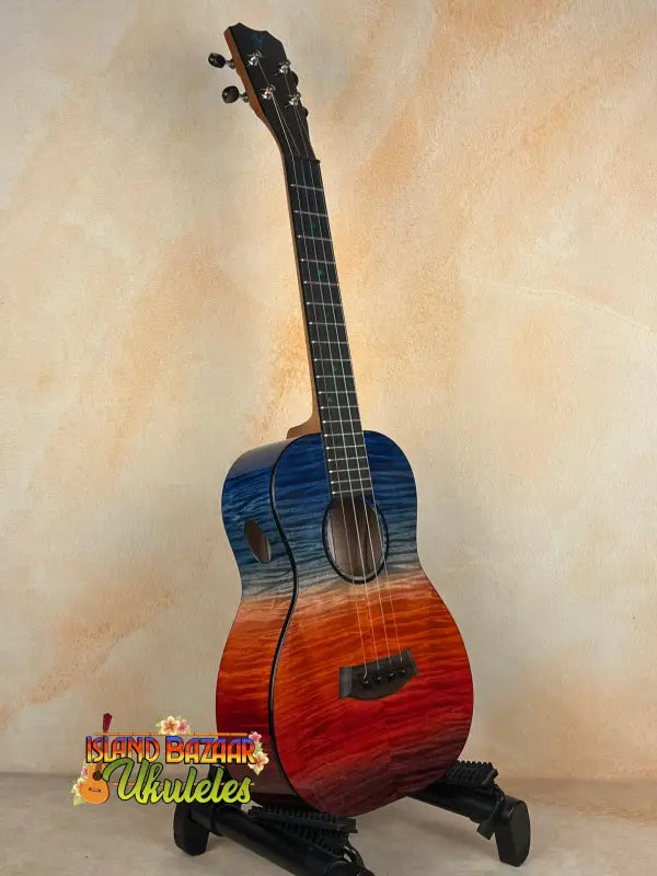 Sunset-colored Kanileʻa ʻILIKAI T Pro Tenor Ukulele on a stand at Island Bazaar