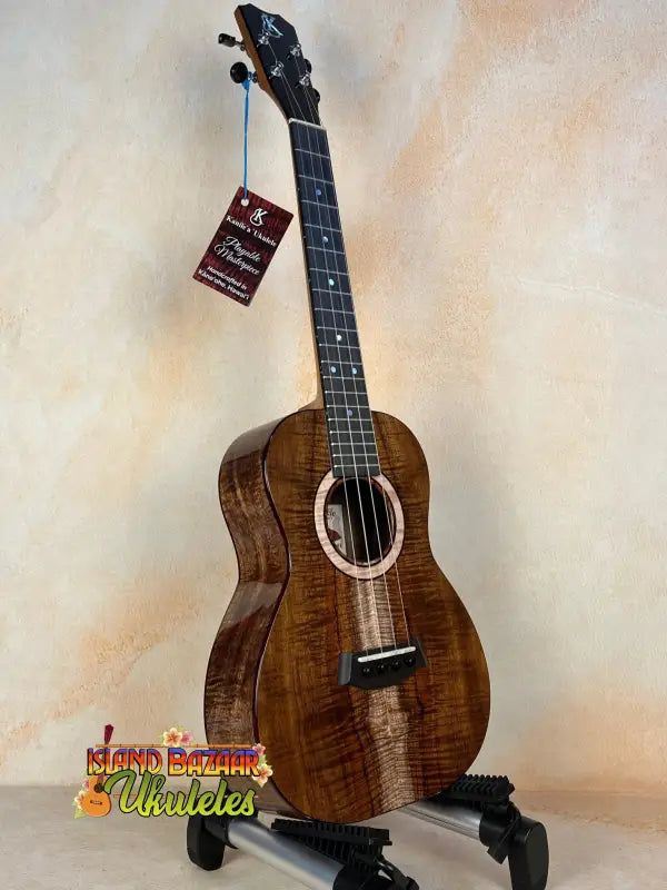 Beautiful Kanile’a K-3 Tenor Ukulele in Master Grade Curly Koa on display stand