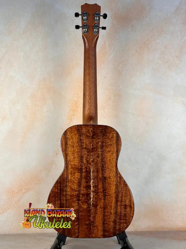 Wooden acoustic Kanile’a K3-T Tenor Koa Ukulele with rich brown finish and case