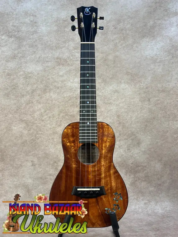 Kanileʻa koa core concert ukulele with rich warm-toned wood finish and intricate grain patterns in deluxe gig bag