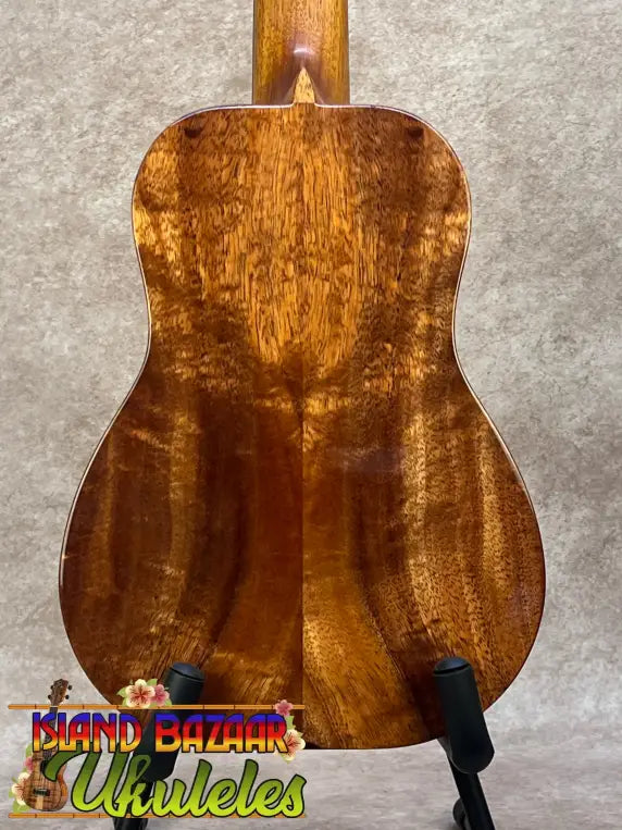 A kanileʻa honus tenor ukulele crafted from mahogany with a warm finish and intricate wood grain patterns with deluxe gig bag