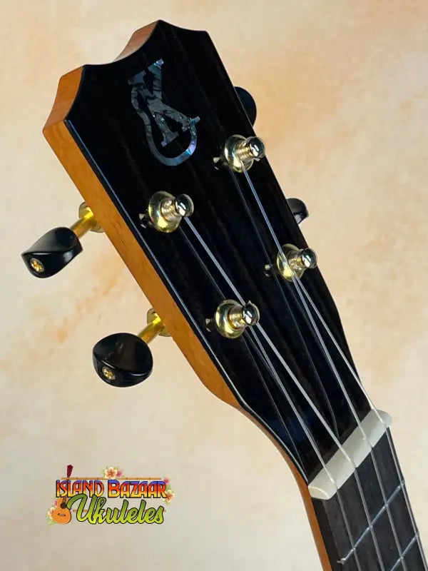 Guitar headstock of Kanilea KPA-C Master Concert Ukulele in black with gold tuning pegs