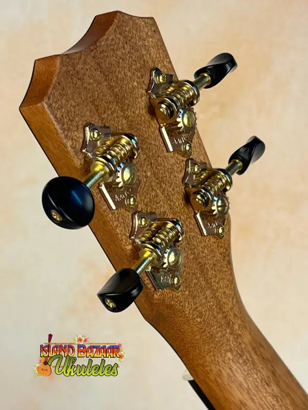 Guitar headstock with gold tuning pegs on Kanilea KPA-C Master Concert Ukulele Hawaiian Koa