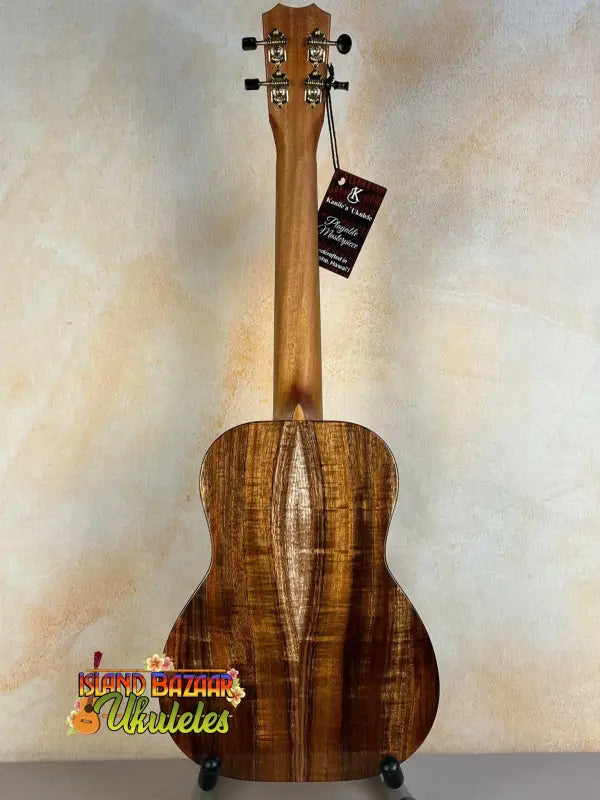 Beautiful Kanilea KPA Curly Koa Tenor Ukulele showcasing rich brown striped grain patterns